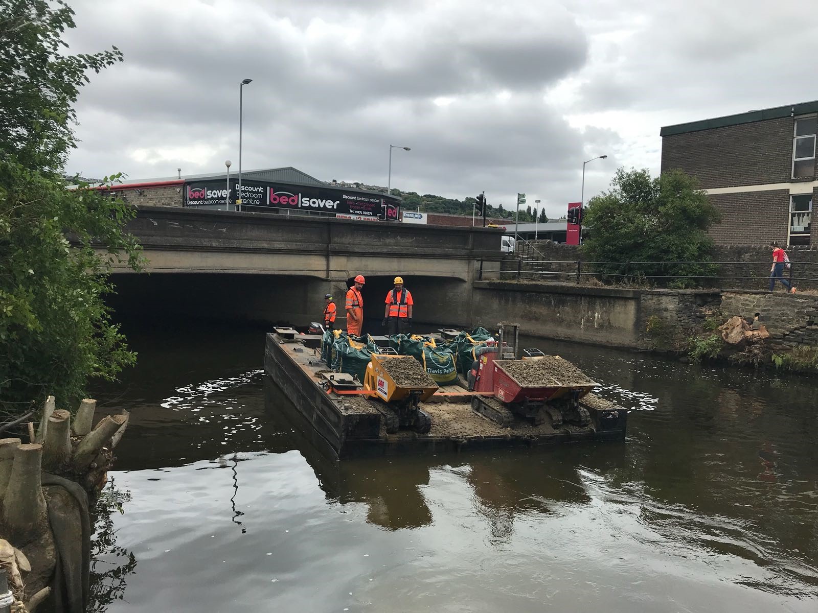 Raft on river with workmen at Baildon Bridge
