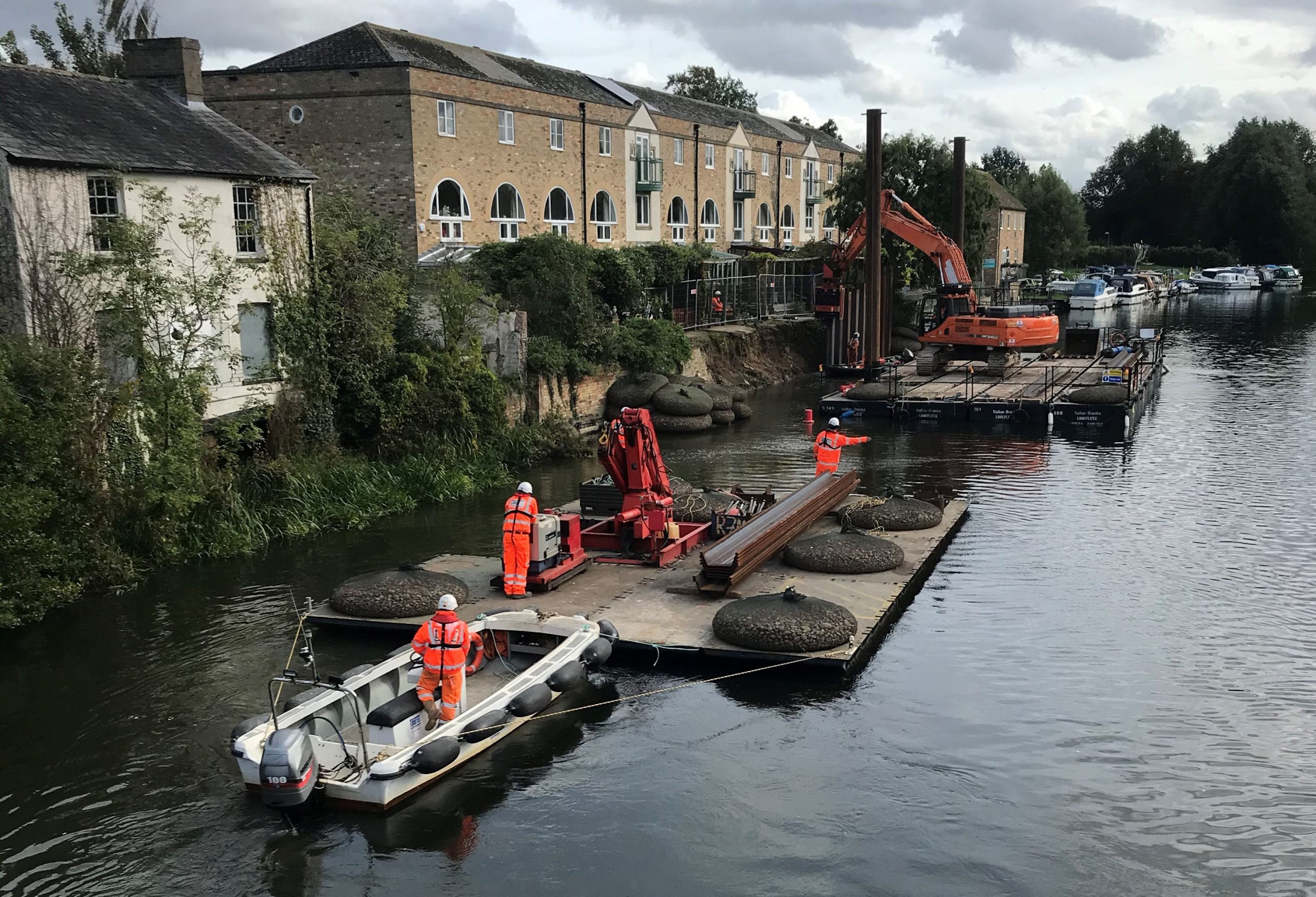 Machine driving supports into river at St Neots